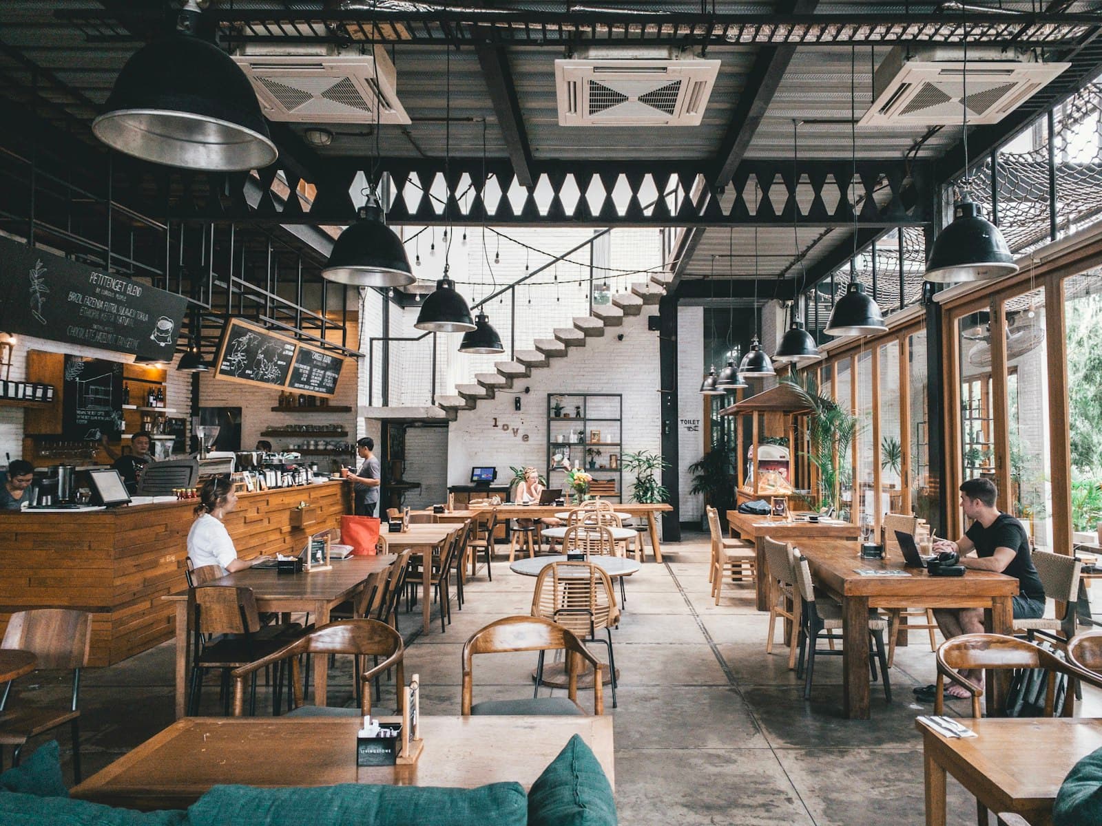 Busy restaurant dining room with guests seated at tables